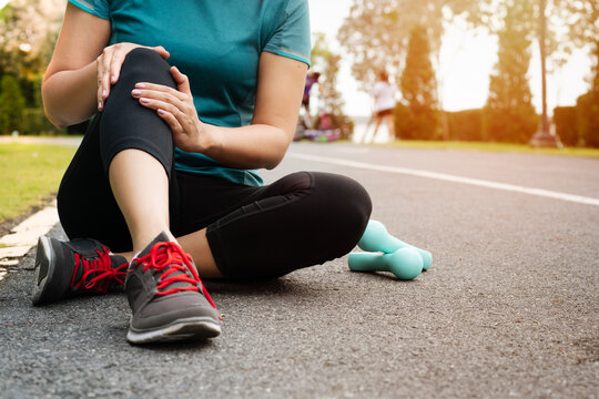 fitness woman runner feel pain on knee. Outdoor exercise activit