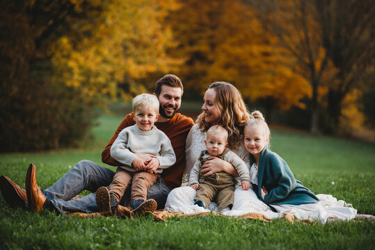 Beautiful family in a park smiling on an Autumn day