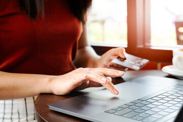 Woman hands holding credit card and using laptop. Online shoppin