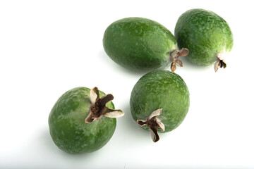 Green feijoa fruit on an isolated white background.