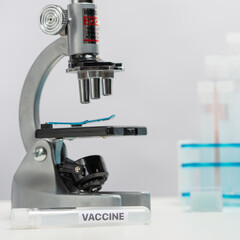 Laboratory with microscope and biological tubes with vaccine. Backstage of scientific discovery. Healthcare concept.