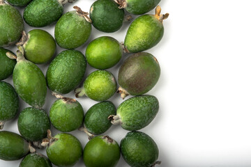 Green feijoa fruit on an isolated white background, with space for text.