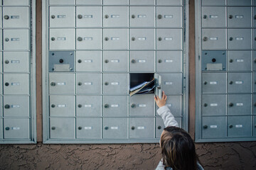 Child unlocks and opens door to cluster mailbox unit
