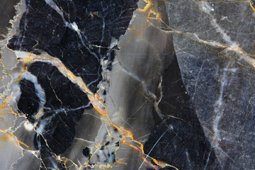 White and orange patterned detailed structure of gray marble (Gold Russia) texture. Abstract dark background.