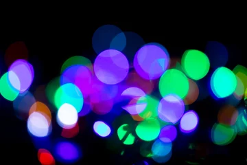 Photo sur Plexiglas Lumière et ombre Taches de lumière multicolores sur fond noir