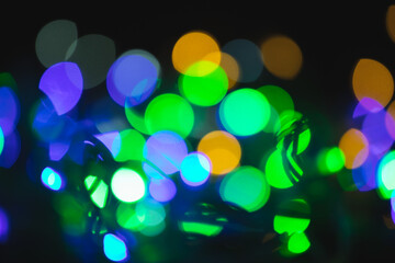 Multicolored spots of light against black background