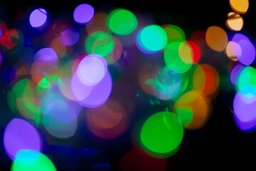 Multicolored spots of light against black background