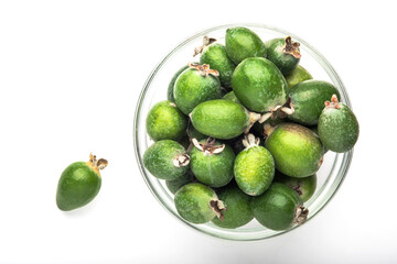 Green feijoa fruit in a glass dish, isolated on a white background. Tropical feijoa fruit. Set of ripe feijoa fruits. the view from the top. Space for copying. Organic food. Vegetarian food. Food stoc