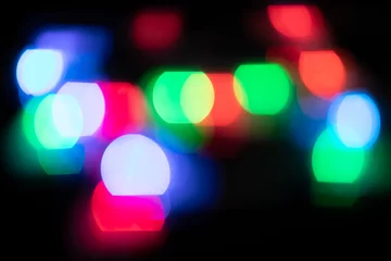 Photo sur Plexiglas Lumière et ombre Multicolored spots of light against black background