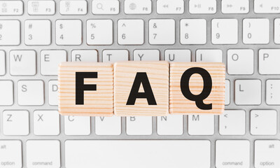 FAQ on black block with keyboard background.