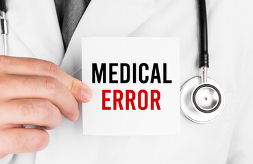 Doctor holding a card with text MEDICAL ERROR, medical concept