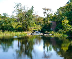 Naklejka na ściany i meble Reflective waters near old mill