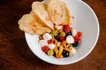 appetizer with pickled mushrooms, olives, parmesan cheese