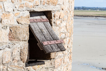 Open wooden shutter in a tower in the ramparts of Mont Saint-Michel
