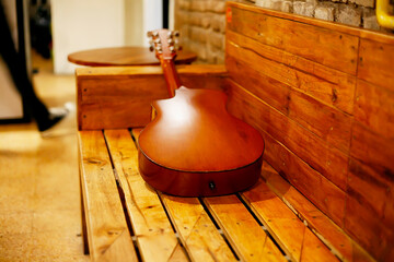wooden chair with acoustic guitar