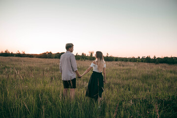 newlyweds hug in the field