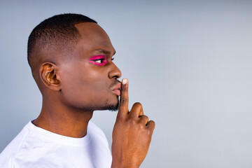 brazilian gender fluid male dressed as female with gorgeous make up in studio white background do not tell anyone