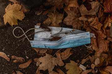 Blue Corona face mask carelessly thrown away
