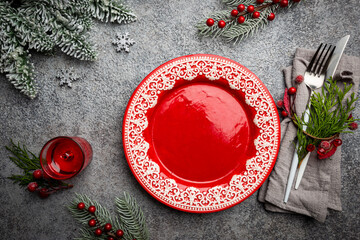 Christmas table setting with christmas decorations on gray background. Top view, copyspace.