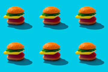 Toy hamburger fast food pattern on blue background