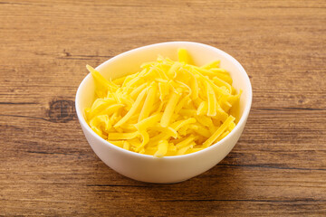 Shredded yellow cheese in the bowl