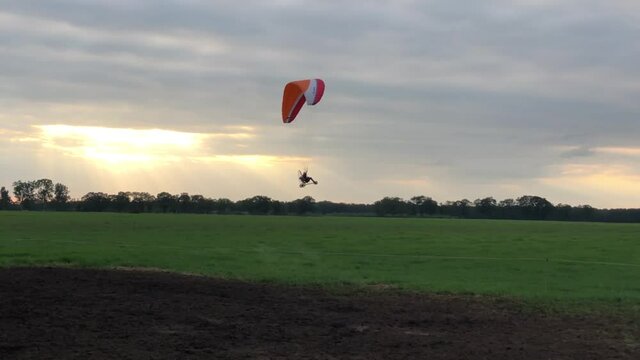 Paramotoring landing in a grass field during sunset around Beerze, Overijssel The Netherlands
