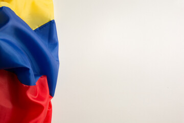 flag of ecuador, venezuela, colombia wrinkled on a white background on the left side