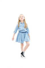 Full length of joyful little girl, dancing. Isolated on white background
