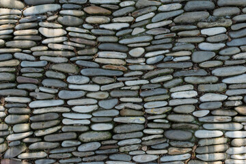 natural background made of flat gray stones stacked close to each other. Copy space for text.