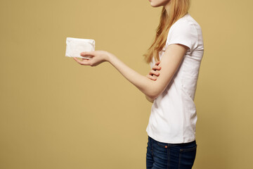 Woman with pad in hand on beige background cropped side view