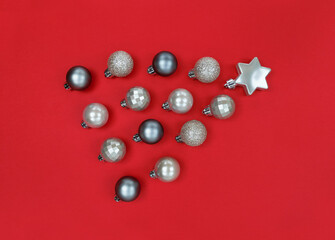 Comet fron Christmas tree baubles on a red paper.