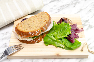 Turkey sandwich with fresh cheese and lettuce. Healthy snack. Close up photo from above