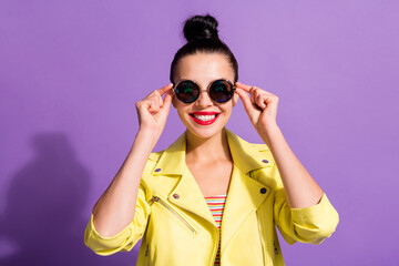 Naklejka premium Portrait of pretty youth girl toothy smile in camera touch cool specs isolated over violet color background
