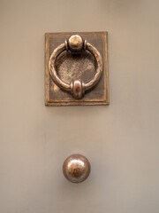 Fototapeta na wymiar close view of copper door knob and hammer