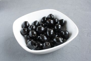 seedless black olives in a bowl on the table