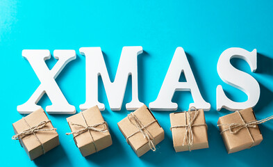 Xmas holiday background. Christmas decorations white letters XMAS, DIY gift box on white. Zero...