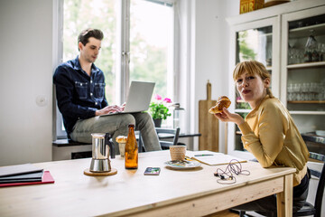Colleagues working from kitchen table