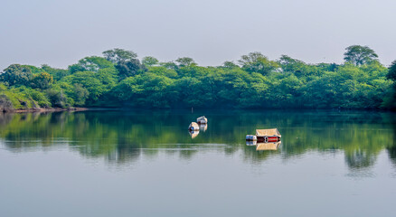 Fototapeta premium Boats moored peacefully on Gajner lake in Rajasthan, India