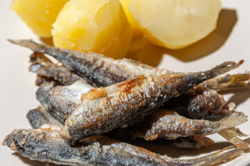 close-up of small fried fish and boiled potatoes