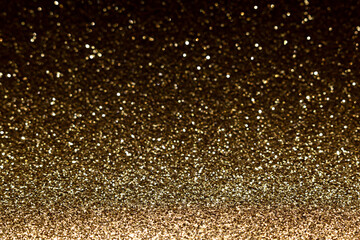 Abstract bokeh gold color with light background.Dark gold color night light elegance,smooth backdrop,artwork design for new year,Christmas sparkling glittering or special day.Selective focus image.