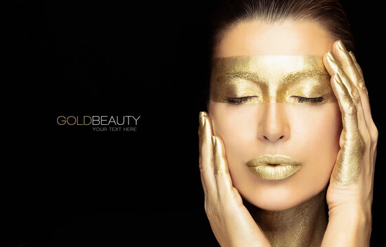 Gold based skincare concept. Beautiful woman face with golden spa treatment