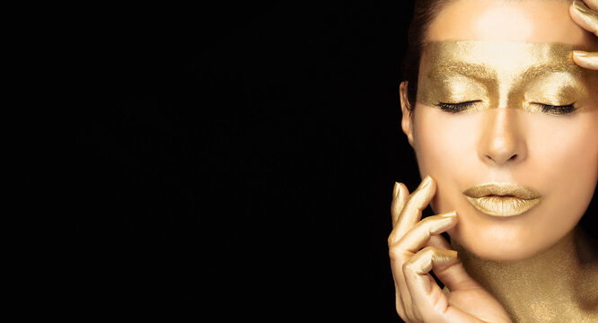 Beauty fashion model girl with healthy glowing skin and shiny metallic golden make up