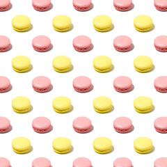 Seamless regular pattern of pink and yellow macaroons