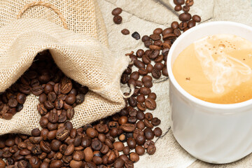 Cappuccino or Coffee with milk cup and roasted beans. Coffee background