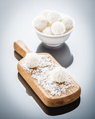 white chocolate truffles on mirror surface with reflection