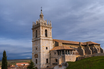 Fototapeta na wymiar old gothic style catholic church lateral view with a dramatic sky in palencia, spain