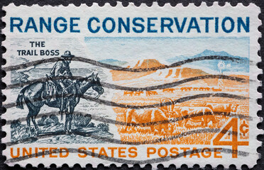 USA - Circa 1961 : a postage stamp printed in the US showing a cowboy on horseback. Pasture in the countryside. Text: Range Conservation. Trail boss