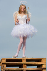 Portrait of little curly blond Angel girl. Concept of innocent child. Love concept. Teenager Cupid....