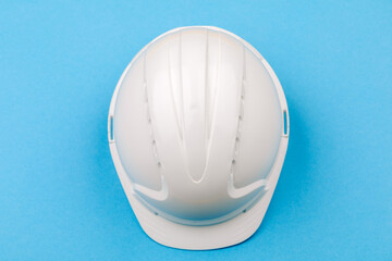 White engineering helmet on a blue background. The view from the top