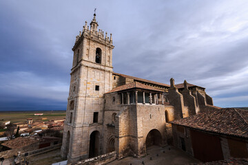 Fototapeta premium old gothic style catholic church front view with a dramatic sky in palencia, spain